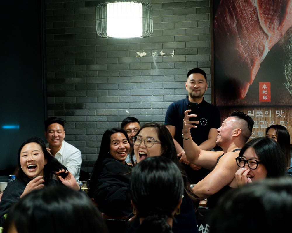 Guests having a laugh during a speech at KAIAN's Chuseok dinner (2023)