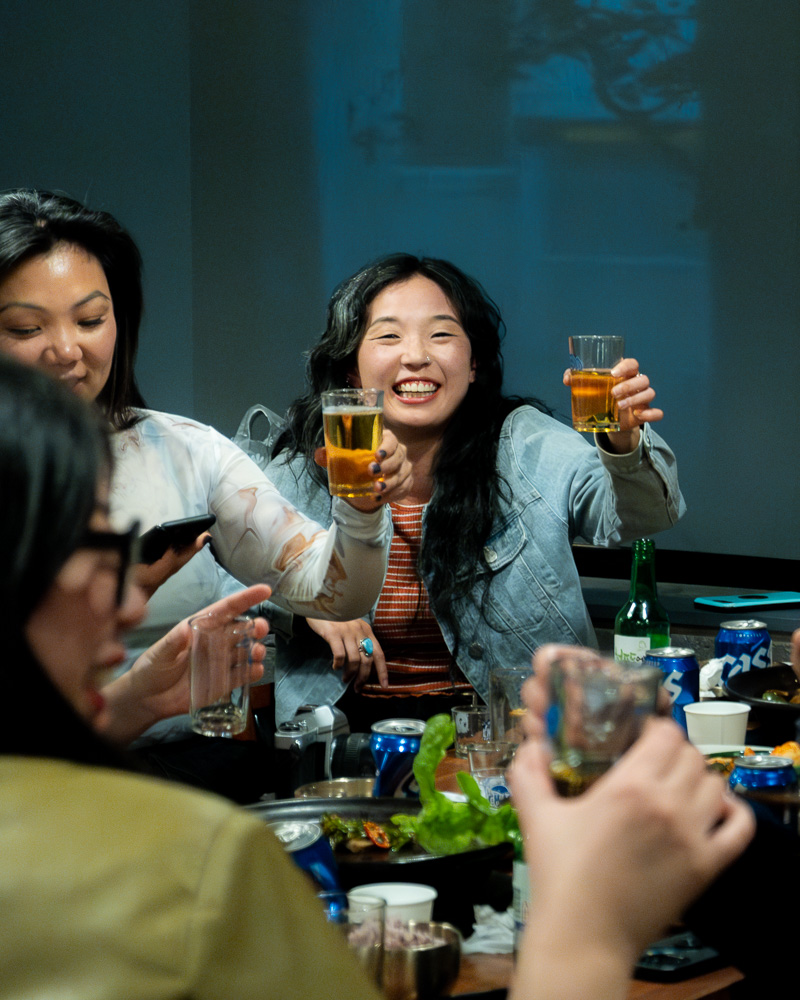 Guests raising a glass and smiling at KAIAN's Chuseok dinner (2023)