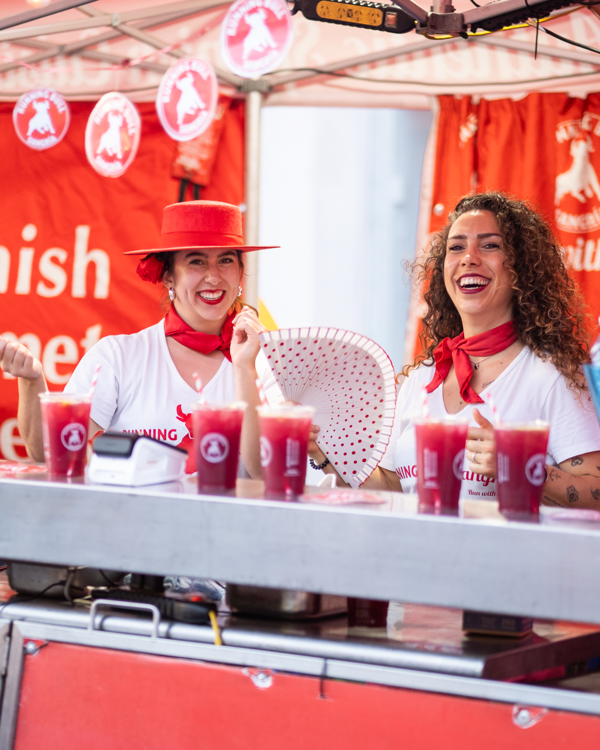 Two vibrant women working at the Spanish food stall at the Johnston St Fiesta in Fitzroy (2026)